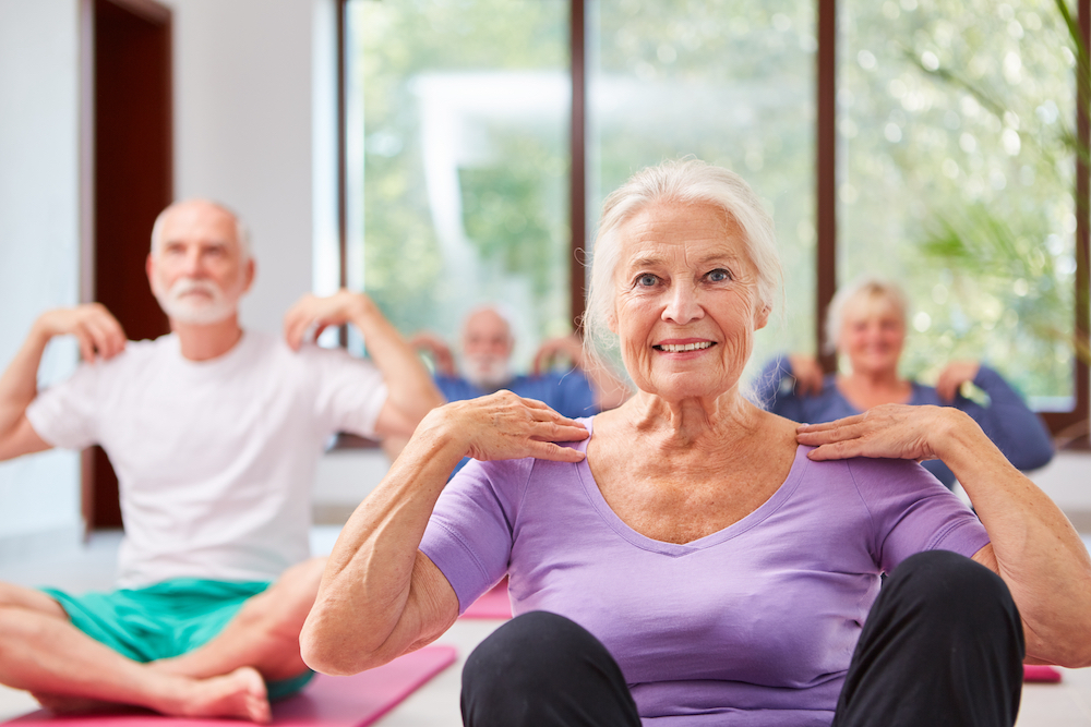 A group of seniors doing yoga together at senior memory care in Vista