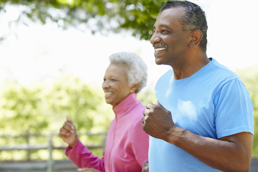 A happy senior couple goes for a jog outdoors